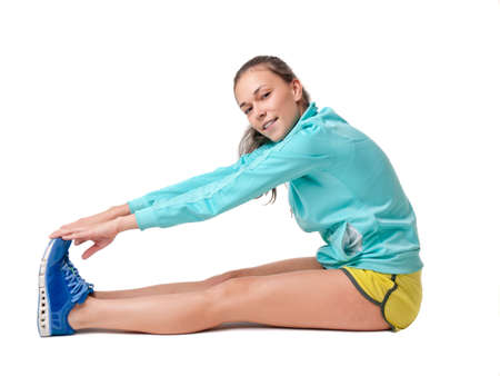 Young woman exercising, white backgroundの写真素材
