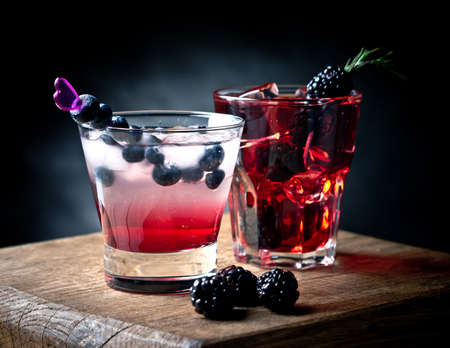 Blueberry and blackberry cocktails on a wooden boardの写真素材