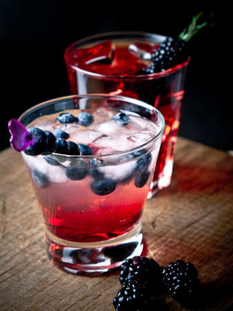 Blueberry and blackberry cocktails on a wooden boardの写真素材