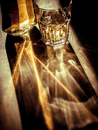 Whiskey on the rocks with back light and strong reflectionsの写真素材