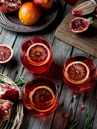 Blood orange and pomegranate cocktails on a grunge wooden tableの写真素材