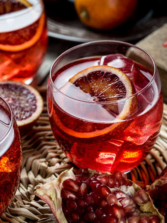 Blood orange and pomegranate cocktails on a grunge wooden tableの写真素材