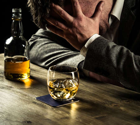 Stressed out businessman drinking whiskey
