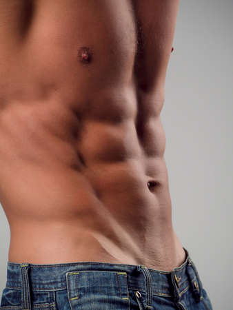 Muscular and fit young man posing shirtlessの写真素材