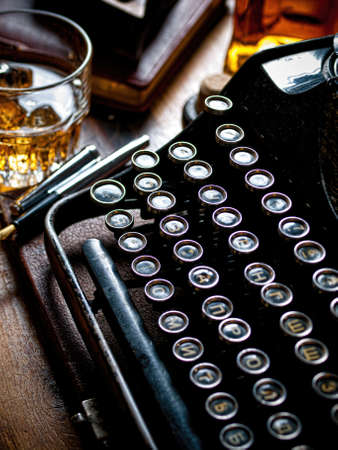 Writers night with a glass of whiskeyの写真素材