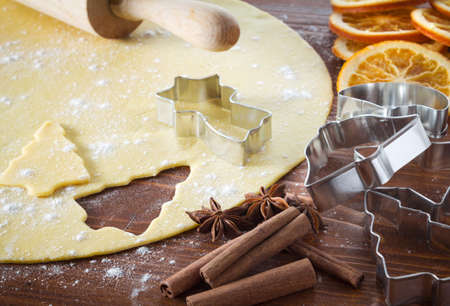 Christmas cookie dough, cookie cutters, spices and nutsの写真素材