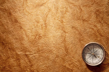 antique compass on vintage paper backgroundの写真素材