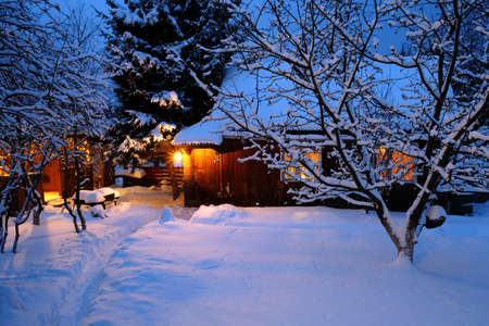 wooden house in winter forestの写真素材
