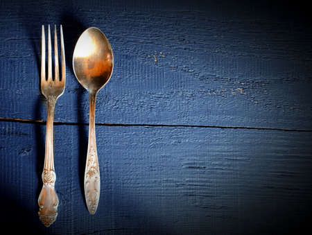 vintage fork and spoon. On Wooden background. Top view.