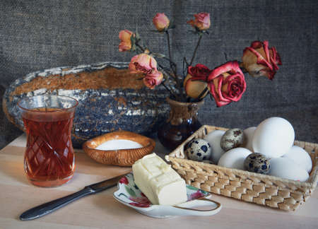 compisition of diary products - bread, tea, eggs butter oil. breakfastの写真素材