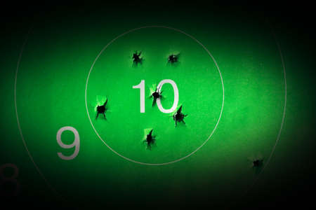 Many bullet holes in the target and intact bullsの写真素材