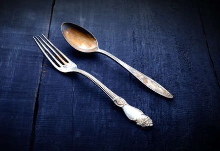 vintage fork and spoon. On Wooden background. Top view.
