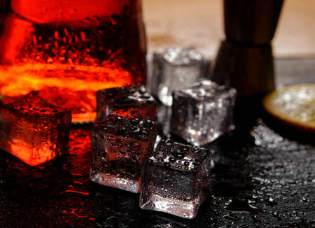 cocktail ice reflections drops light background waterの写真素材