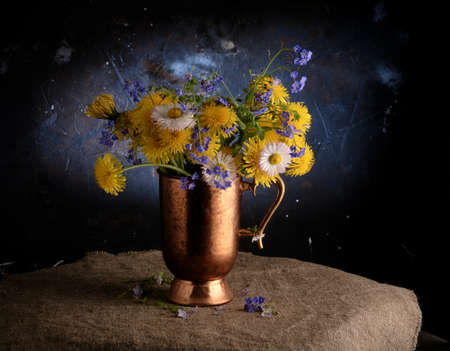 Spring composition: a bouquet of forget-me-nots and dandelionsの写真素材
