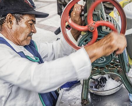 A man making traditional ice-cream in the street marketのeditorial素材