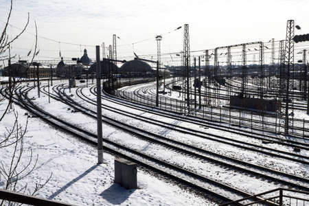 Stretching into the distance railway tracks in winter in Lviv, almost black and white due to weatherの写真素材