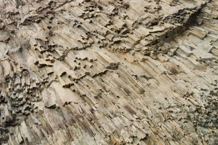 The complicated structure of volcanic rock at Cape Fiolent in Crimea. Rocks split off and forming...
