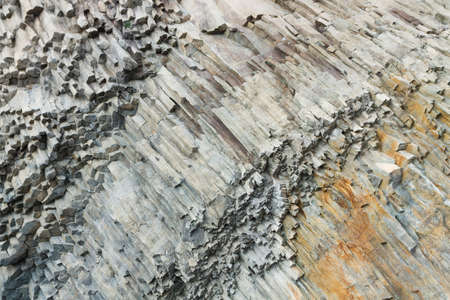 The complicated structure of volcanic rock at Cape Fiolent in Crimea. Rocks split off and forming...