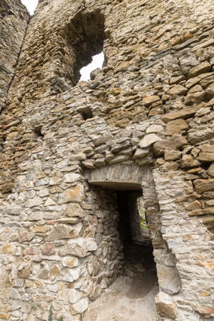 Wall of ancient abandoned fortress in Slovakia with window and door openingsの写真素材