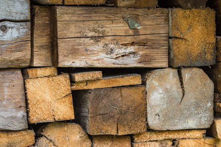 Pile of wet firewood stacked on top of each other. Stack of forms texture of square cross-sections...