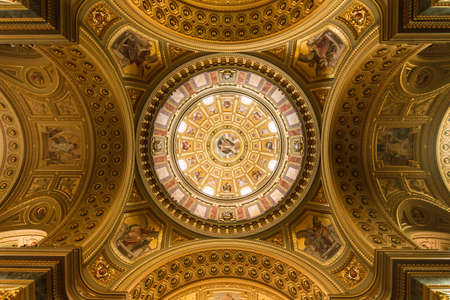 Dome of the temple of the Holy Dormition Cathedral in Budapest inside. Richly decorated with gold details and painted walls on the wide angleのeditorial素材