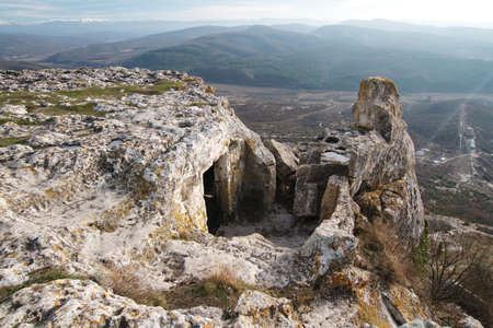 Cave city Tepe-Kerman in the Crimea. The ancient city among the rocks on the background of a mountain rangeの写真素材