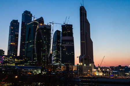 Main Moscow city center located at the capital of Russia on the Moscow river shore at winter evening with reflections on waterの写真素材