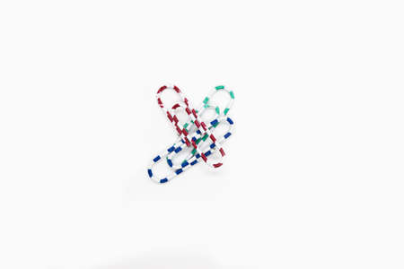 Office paper clips on a white background.