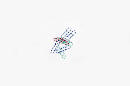 Office paper clips on a white background.