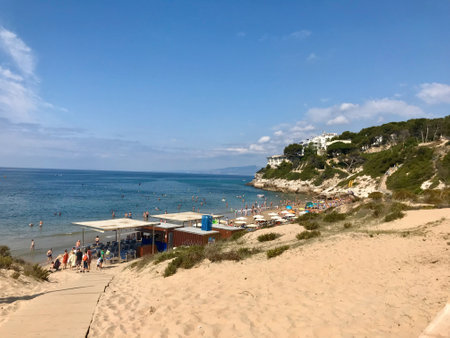 Salou, Spain, June 2019 - A group of people sitting on a sandy beach. High quality photoの写真素材