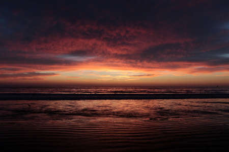 Orange sunset with clouds on the Pacific Ocean, background
