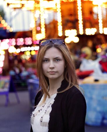 portrait of a young cute girl in the street at nightの写真素材