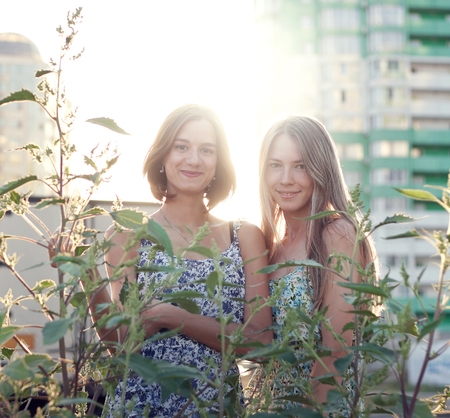 a pair of cute girls smiling in the streetの写真素材