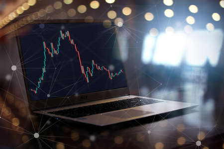 finger on laptoppressing button to by crypto currency bitcoin on market online. mixed media technology finance backgroundの写真素材