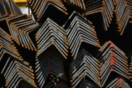 Steel angles. Stuck og L-beams on the warehouse. Metal rolled angle bar.の写真素材