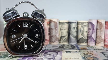 Time and Money concept with white background.の写真素材