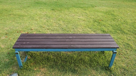 Wooden chair on green grass in the garden