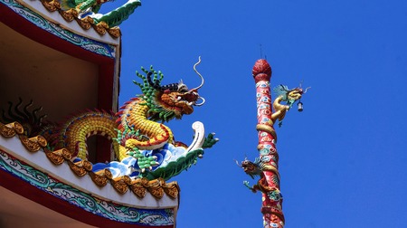 colorful dragon on top roof in the blue sky. Dragon is show power authority of king and majestyの写真素材