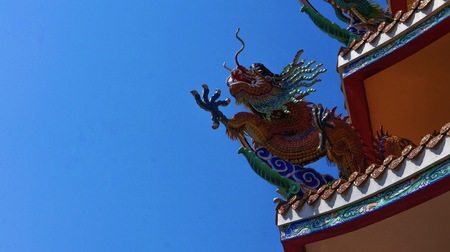colorful dragon on top roof in the blue sky. Dragon is show power authority of king and majestyの写真素材