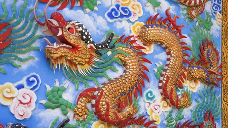 colorful dragon on top roof in the blue sky. Dragon is show power authority of king and majestyの写真素材