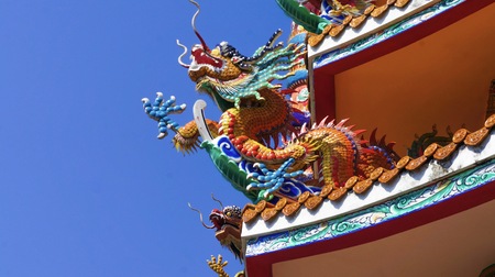 colorful dragon on top roof in the blue sky. Dragon is show power authority of king and majestyの写真素材