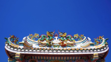 colorful dragon on top roof in the blue sky. Dragon is show power authority of king and majestyの写真素材