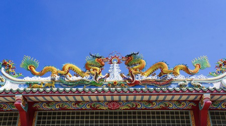 colorful dragon on top roof in the blue sky. Dragon is show power authority of king and majestyの写真素材