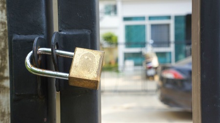 master key lock on gate and door of fence.の写真素材