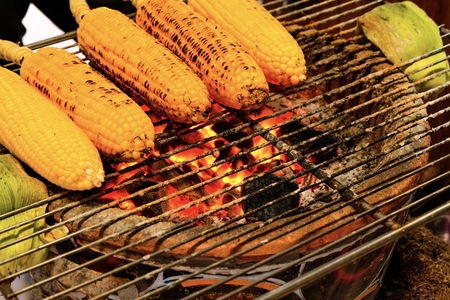 Yellow corn grilled by traditional charcoal for barbecue party in holiday.の写真素材