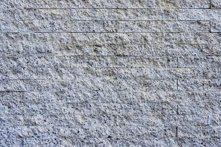 Grey granite rock and stone from wall for background and texture.の写真素材
