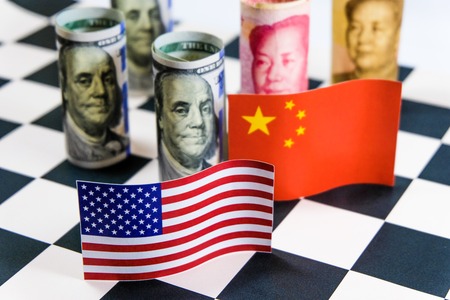 America dollar and Yuan banknote with USA and China flags. Its is symbol for tariff trade war crisis between biggest economic country in the world.の写真素材