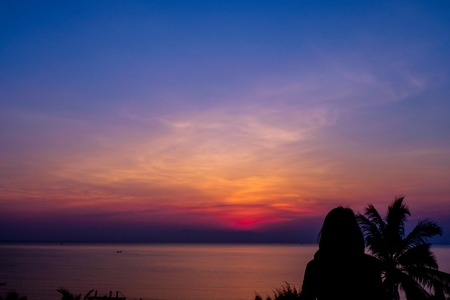 Alone woman standing and see sea in the morning time. Relaxation and freshness on holiday concept.の写真素材