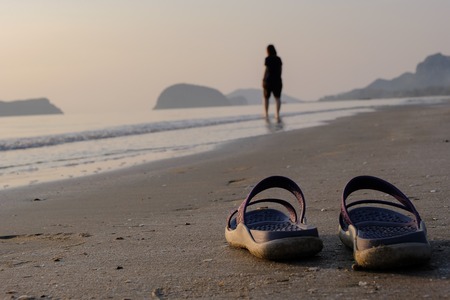Work Life Balance Concept, woman take a shoes on the beach for relaxation on holiday.の写真素材