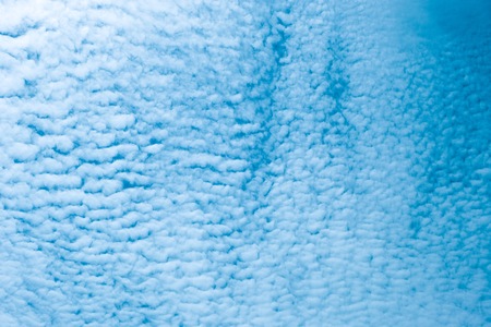 Fluffy and little clouds against with light blue sky.の写真素材